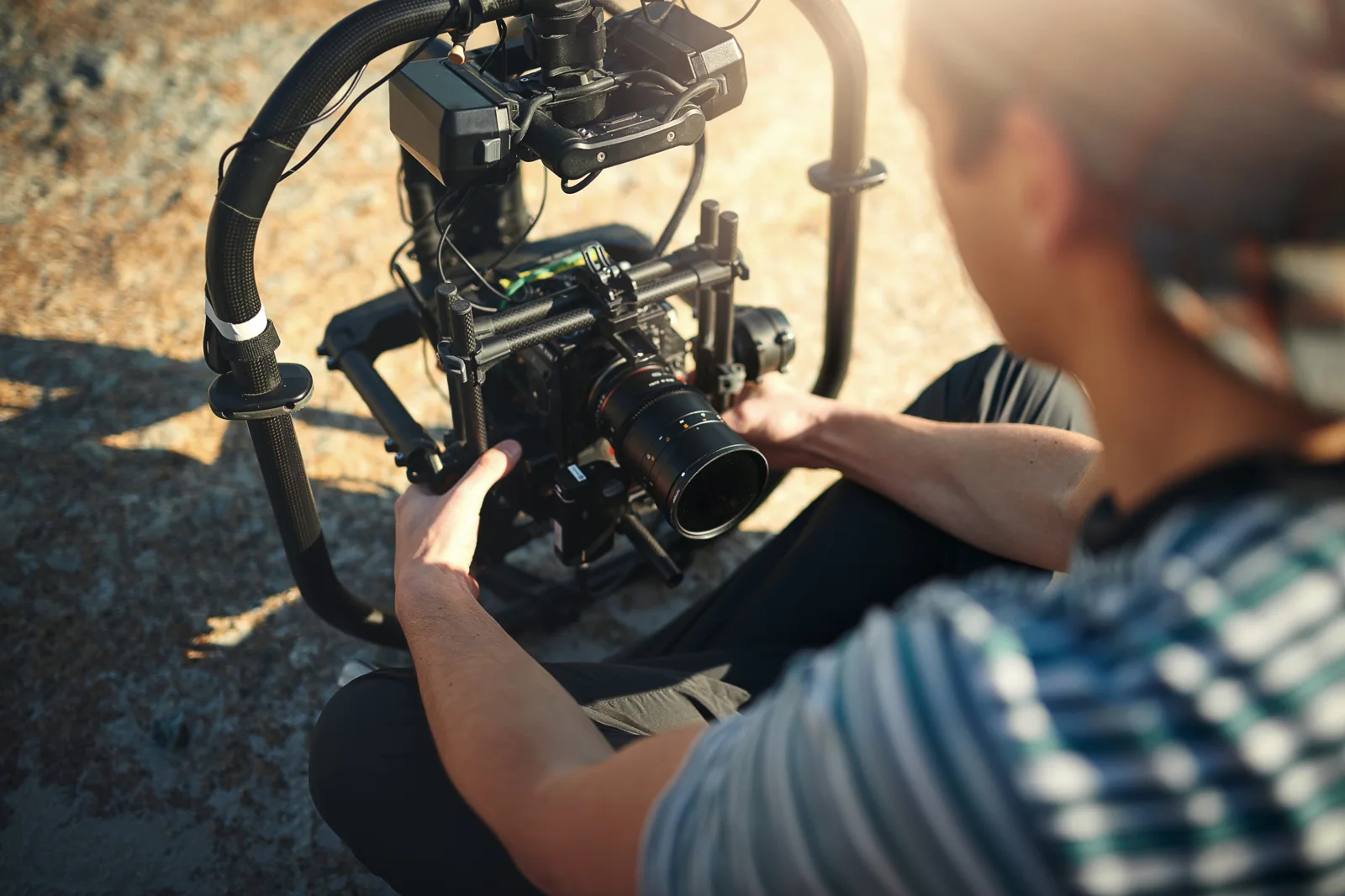 Close-up of a camera operator preparing a professional cinema camera